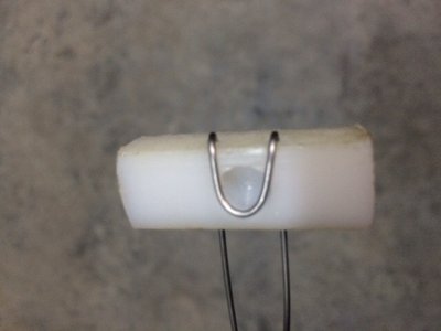 Teflon block with safety wire that wraps around the Monadnock fastener